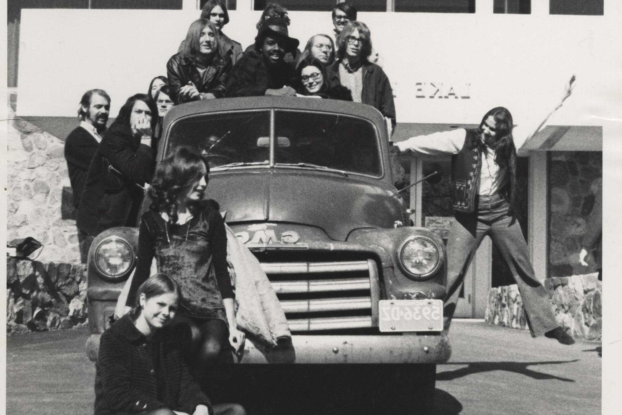 Thomas Jefferson College students posing on truck in front of Lake Huron Hall. Keep on Truckin' poster was based on this series of images.